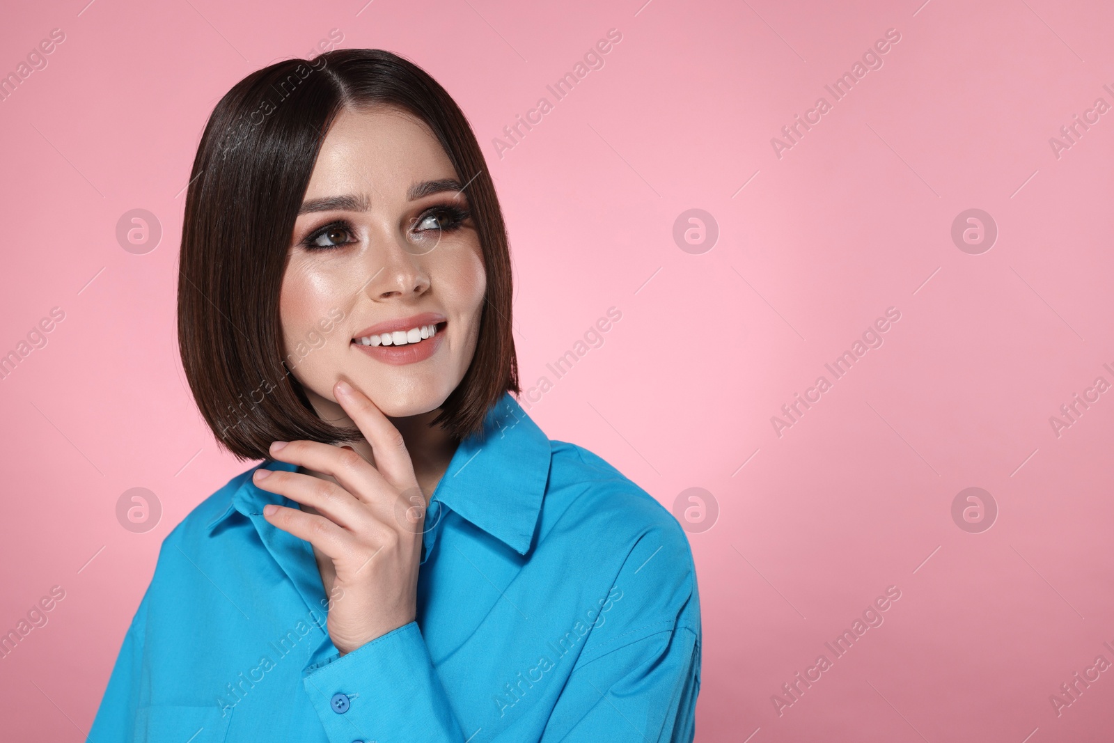 Photo of Portrait of beautiful young happy woman with gorgeous straight hair on pink background, space for text