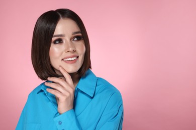 Portrait of beautiful young happy woman with gorgeous straight hair on pink background, space for text