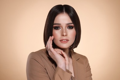 Photo of Portrait of beautiful young woman with gorgeous straight hair on beige background