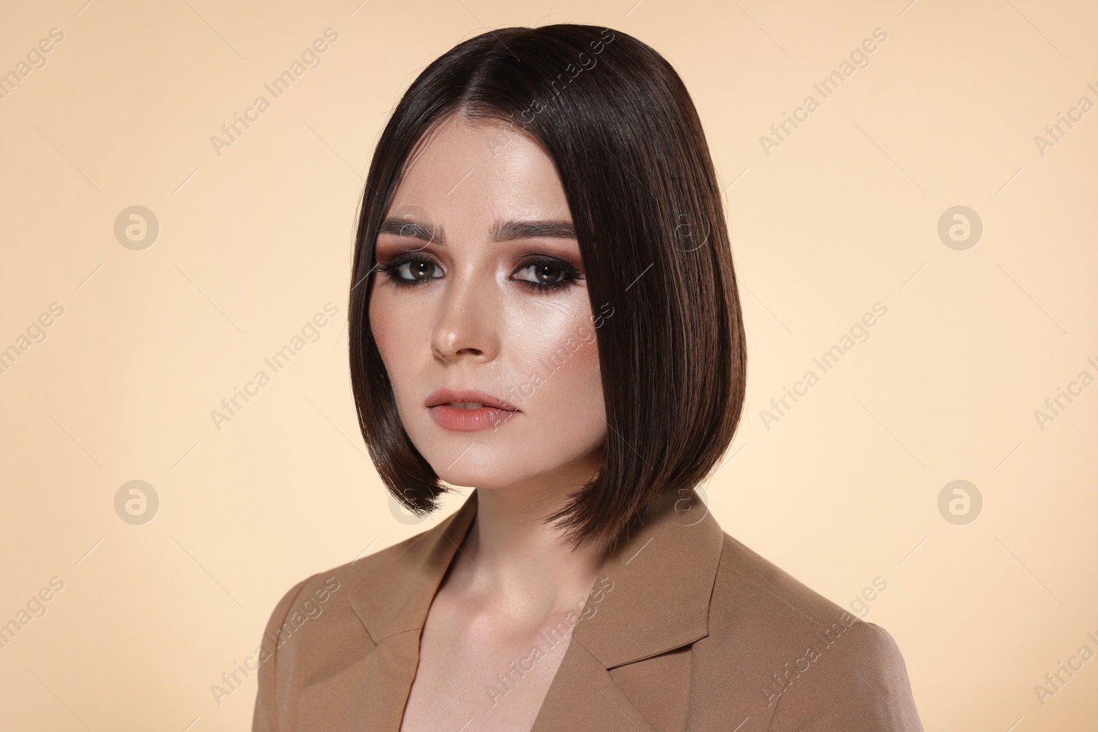 Photo of Portrait of beautiful young woman with gorgeous straight hair on beige background