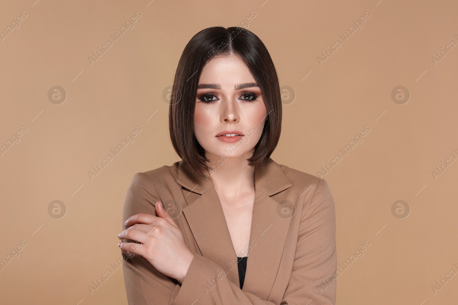 Photo of Portrait of beautiful young woman with gorgeous straight hair on beige background