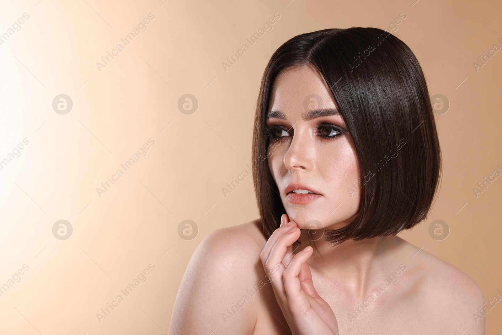 Photo of Portrait of beautiful young woman with gorgeous straight hair on beige background, space for text