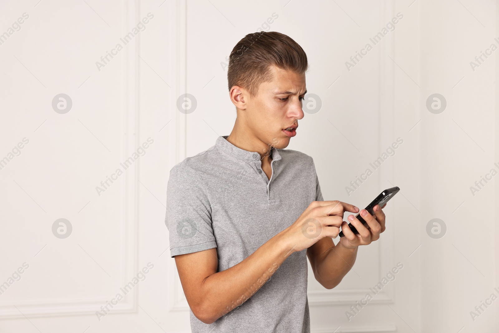 Photo of Stressed man calling hotline for mental health help indoors