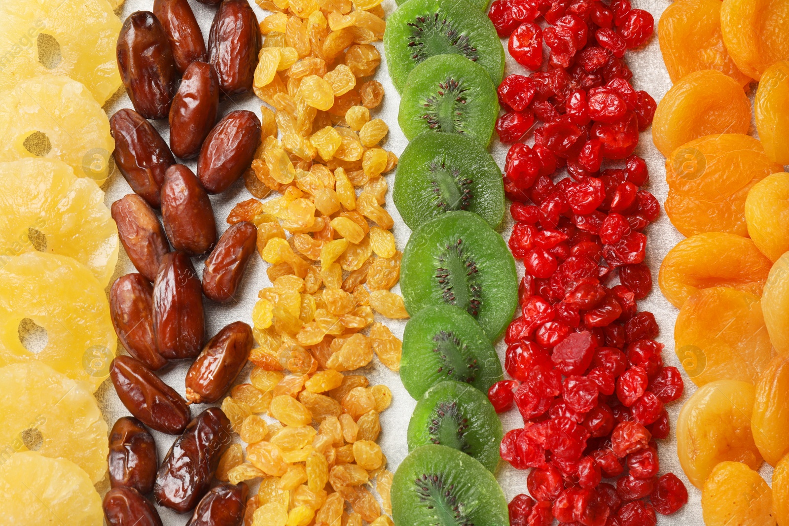 Photo of Different dried fruits on light table, flat lay