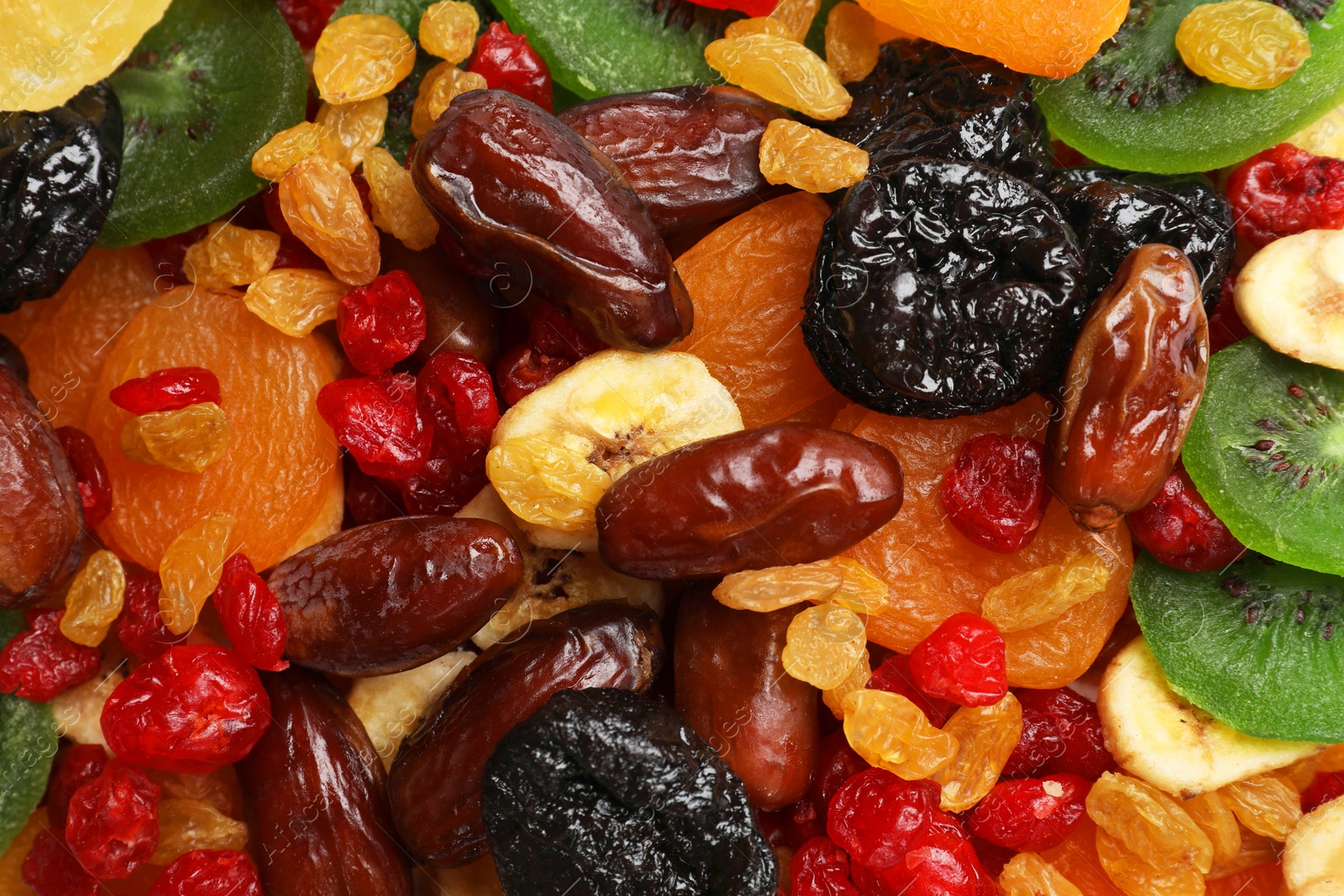 Photo of Mix of different dried fruits as background, closeup