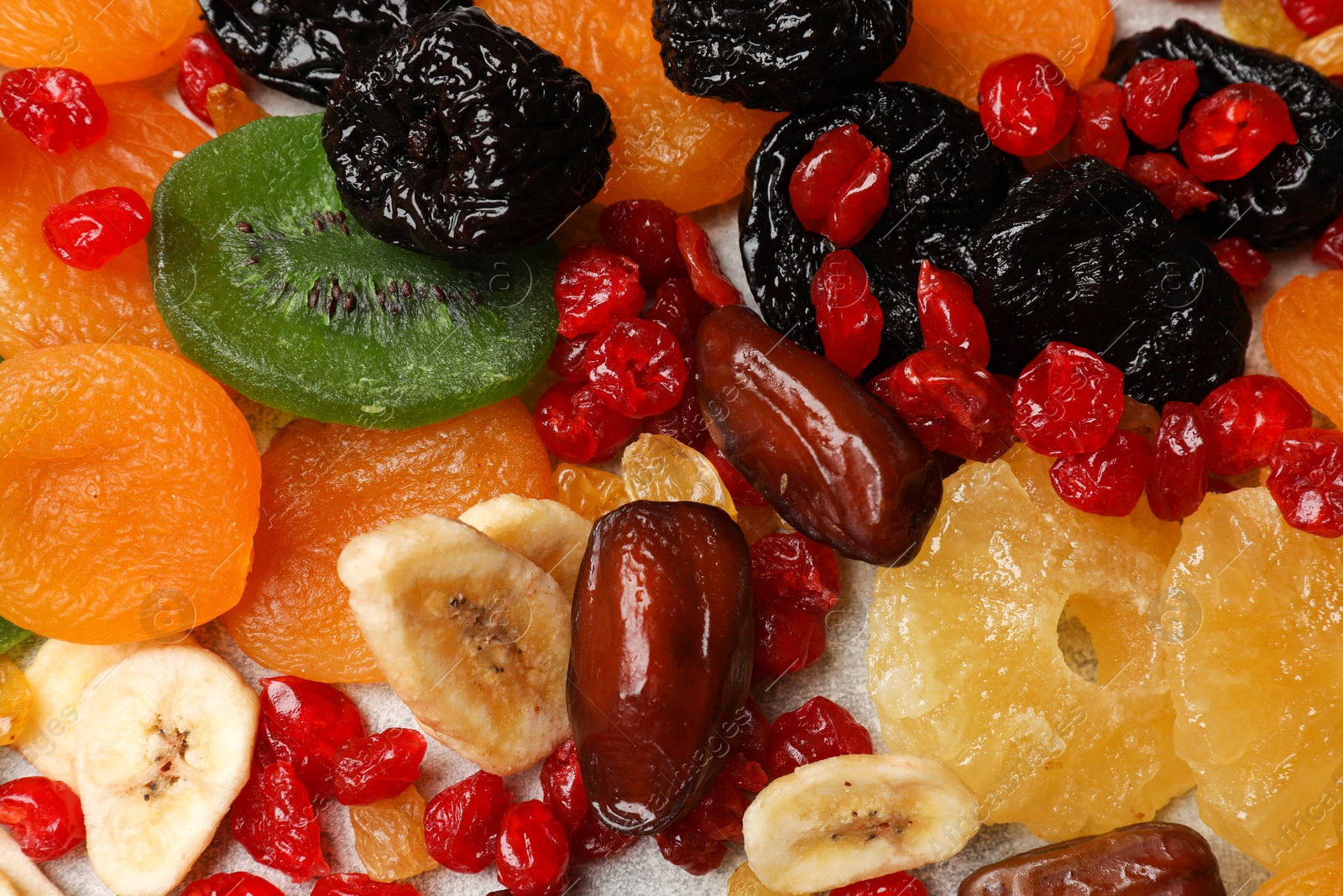 Photo of Mix of different dried fruits on table, top view