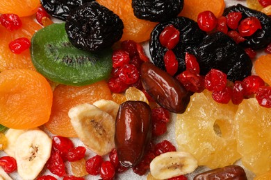 Photo of Mix of different dried fruits on table, top view