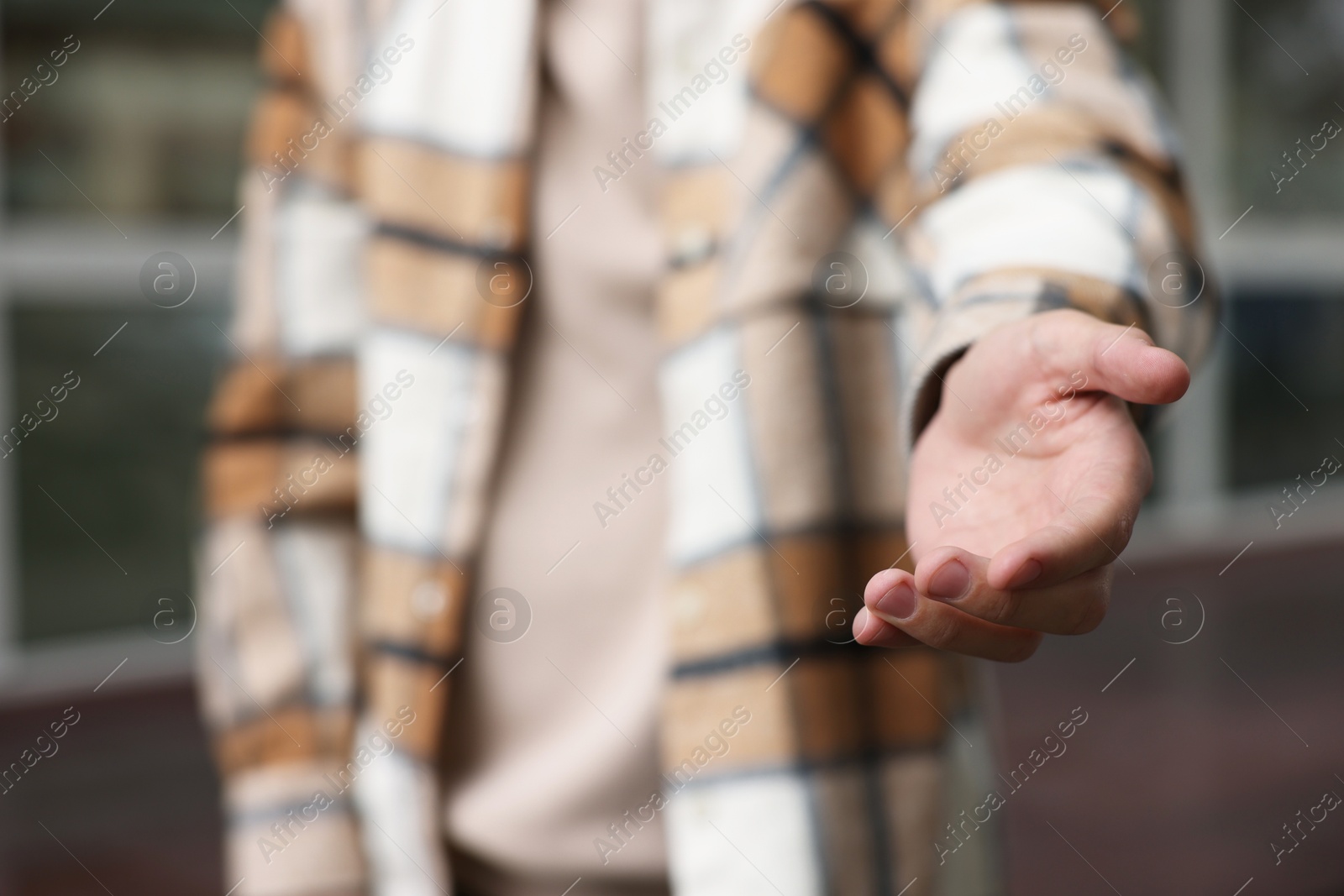 Photo of Offering help. Man reaching his hand outdoors, closeup