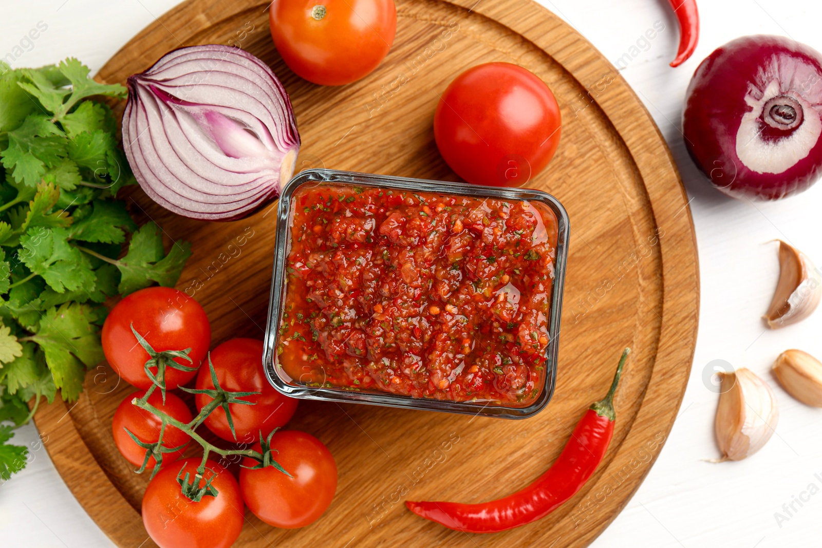 Photo of Delicious salsa sauce and ingredients on white wooden table, flat lay