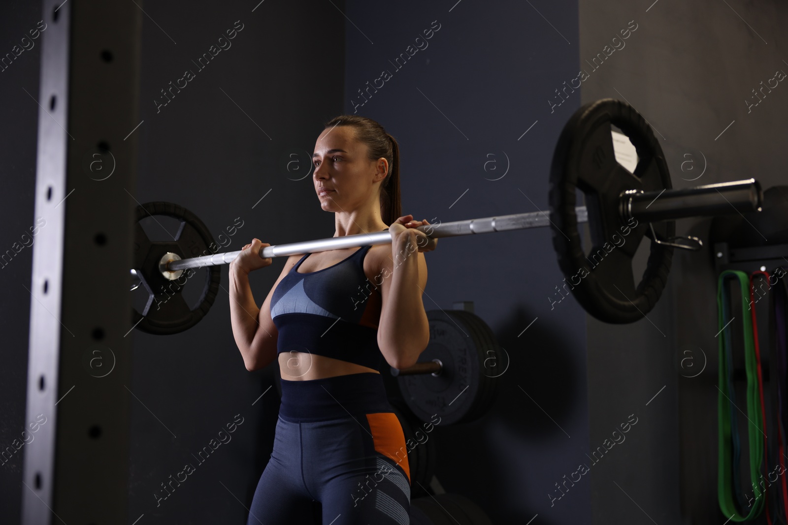 Photo of Sportswoman with barbell during crossfit workout in gym