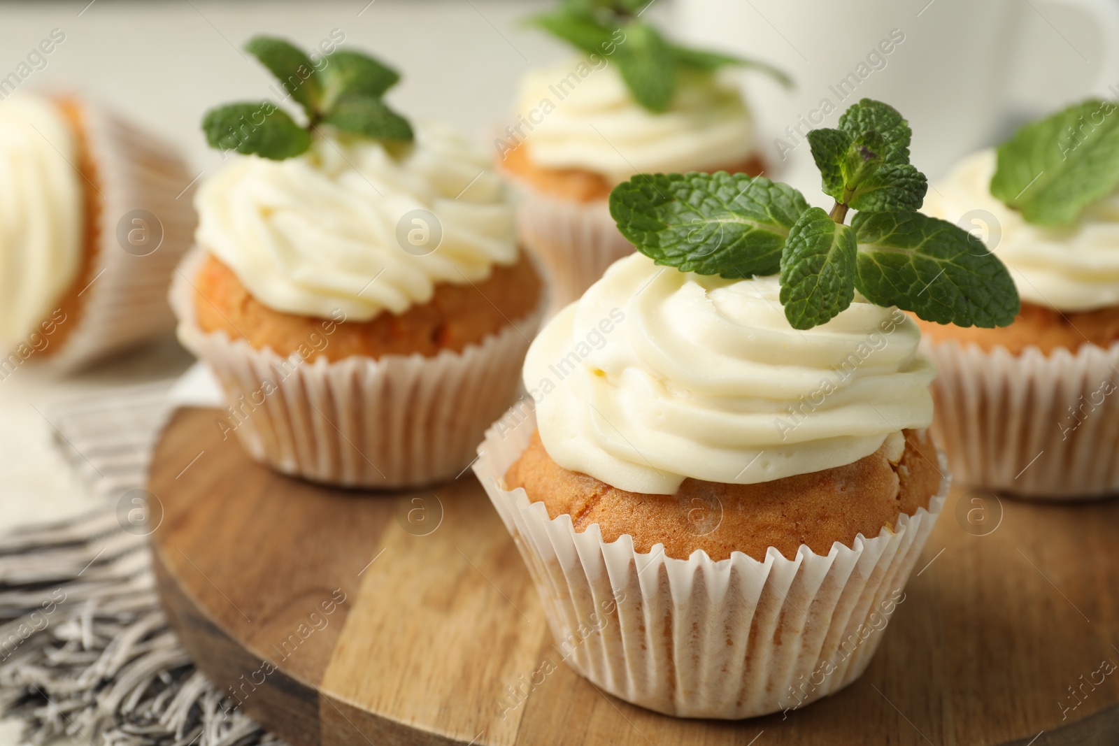 Photo of Delicious carrot cupcakes with mint on table, closeup