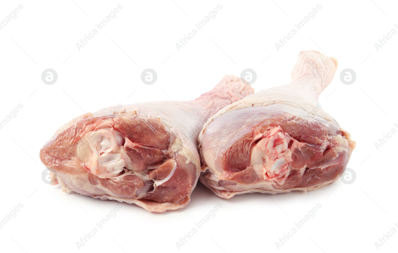 Photo of Two raw turkey drumsticks isolated on white