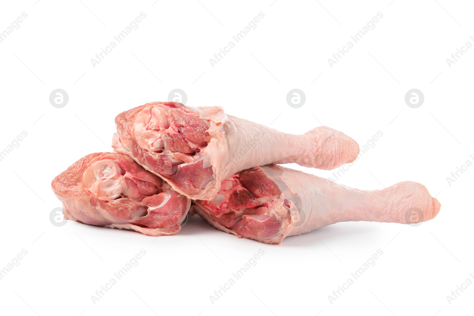 Photo of Three raw turkey drumsticks isolated on white