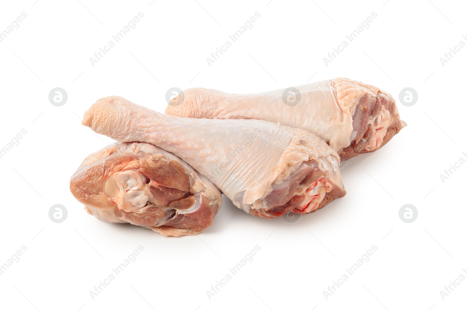 Photo of Three raw turkey drumsticks isolated on white