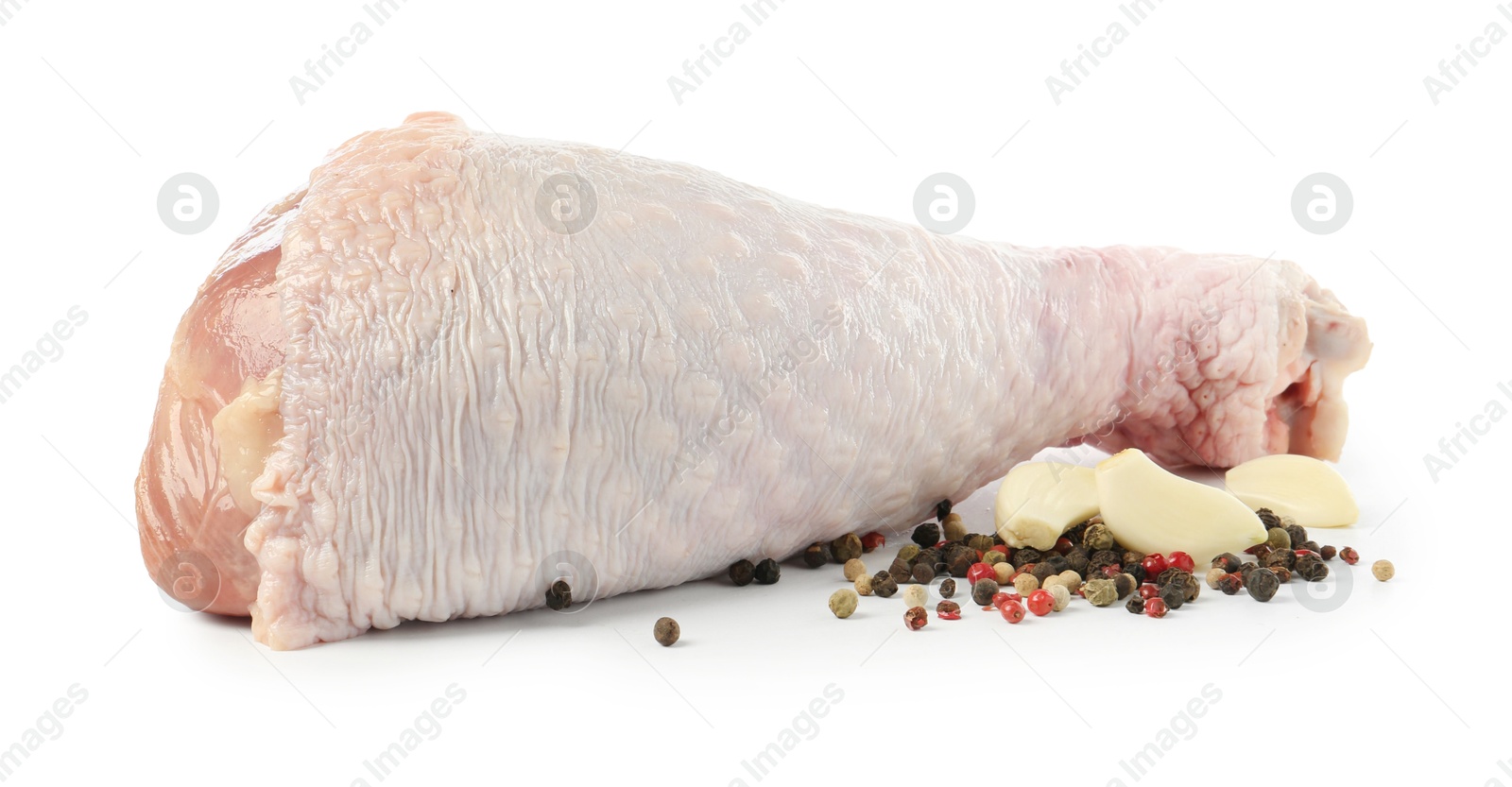 Photo of Raw turkey drumstick and spices isolated on white