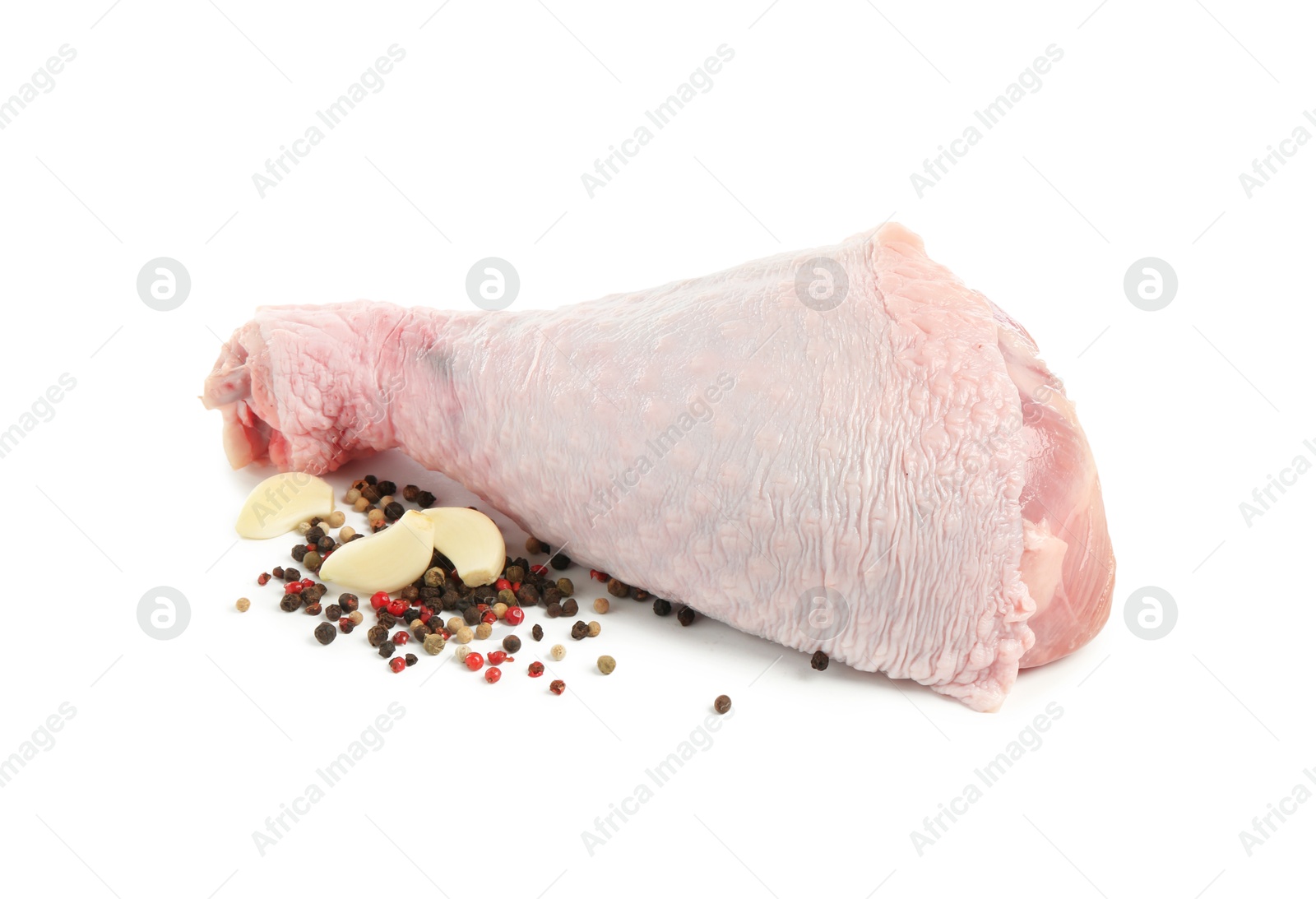 Photo of Raw turkey drumstick and spices isolated on white