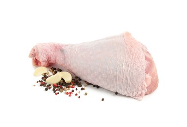 Raw turkey drumstick and spices isolated on white