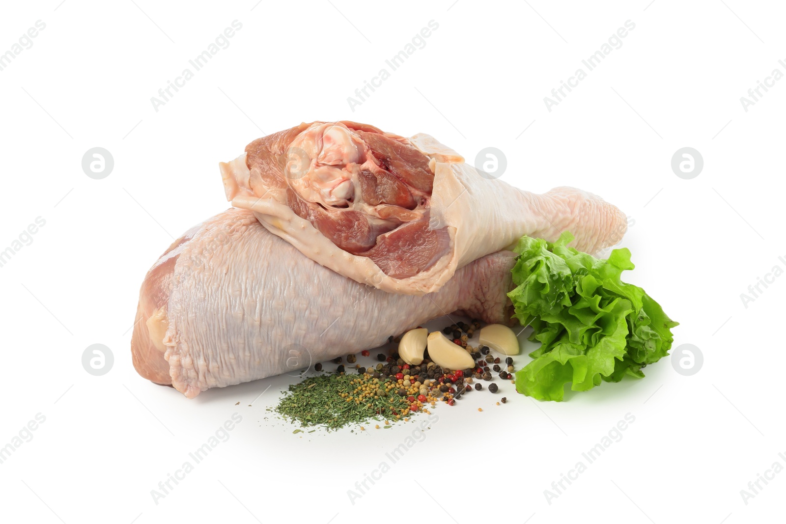 Photo of Raw turkey drumsticks and spices isolated on white