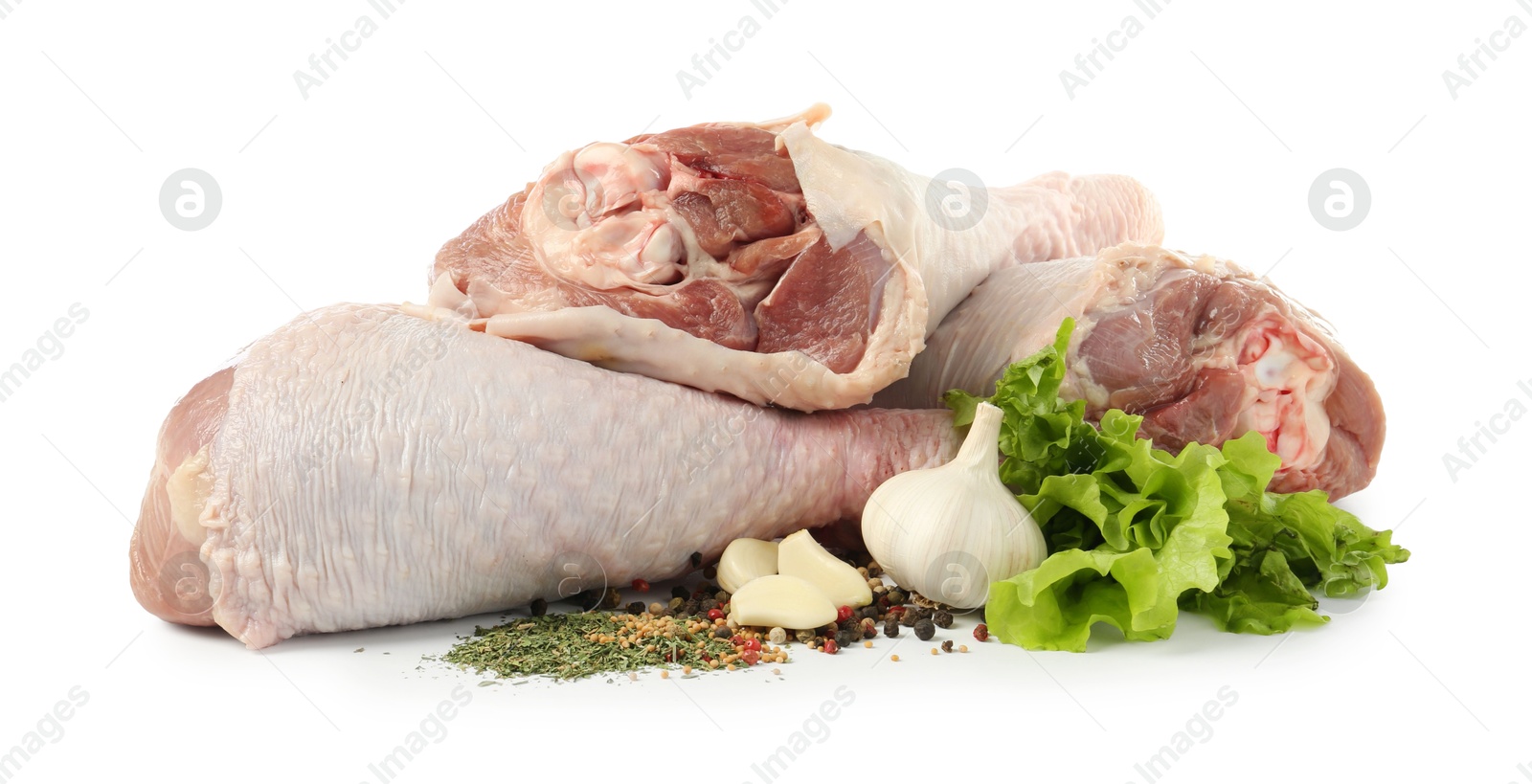 Photo of Raw turkey drumsticks and spices isolated on white