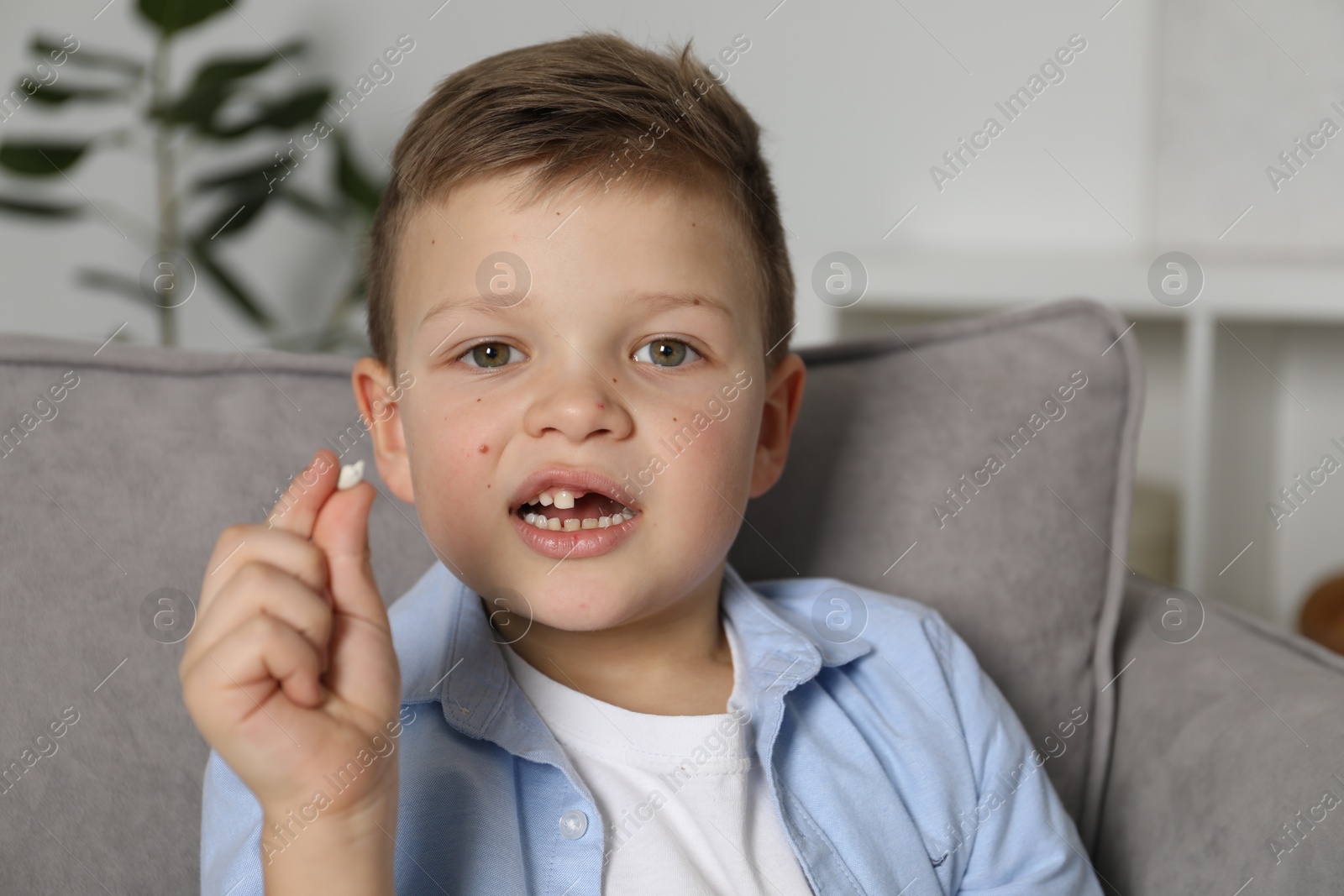 Photo of Cute little boy with missing tooth at home. Waiting for tooth fairy