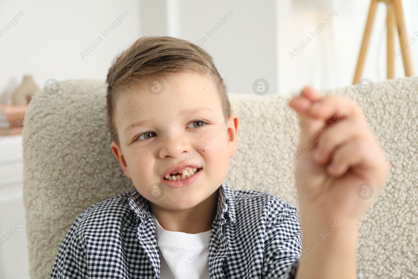 Photo of Cute little boy with missing tooth at home. Waiting for tooth fairy