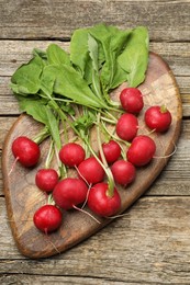 Photo of Many fresh radishes on wooden table, top view