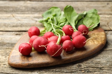 Photo of Many fresh radishes on wooden table, closeup