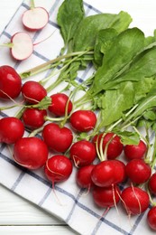 Photo of Many fresh radishes on white wooden table, top view