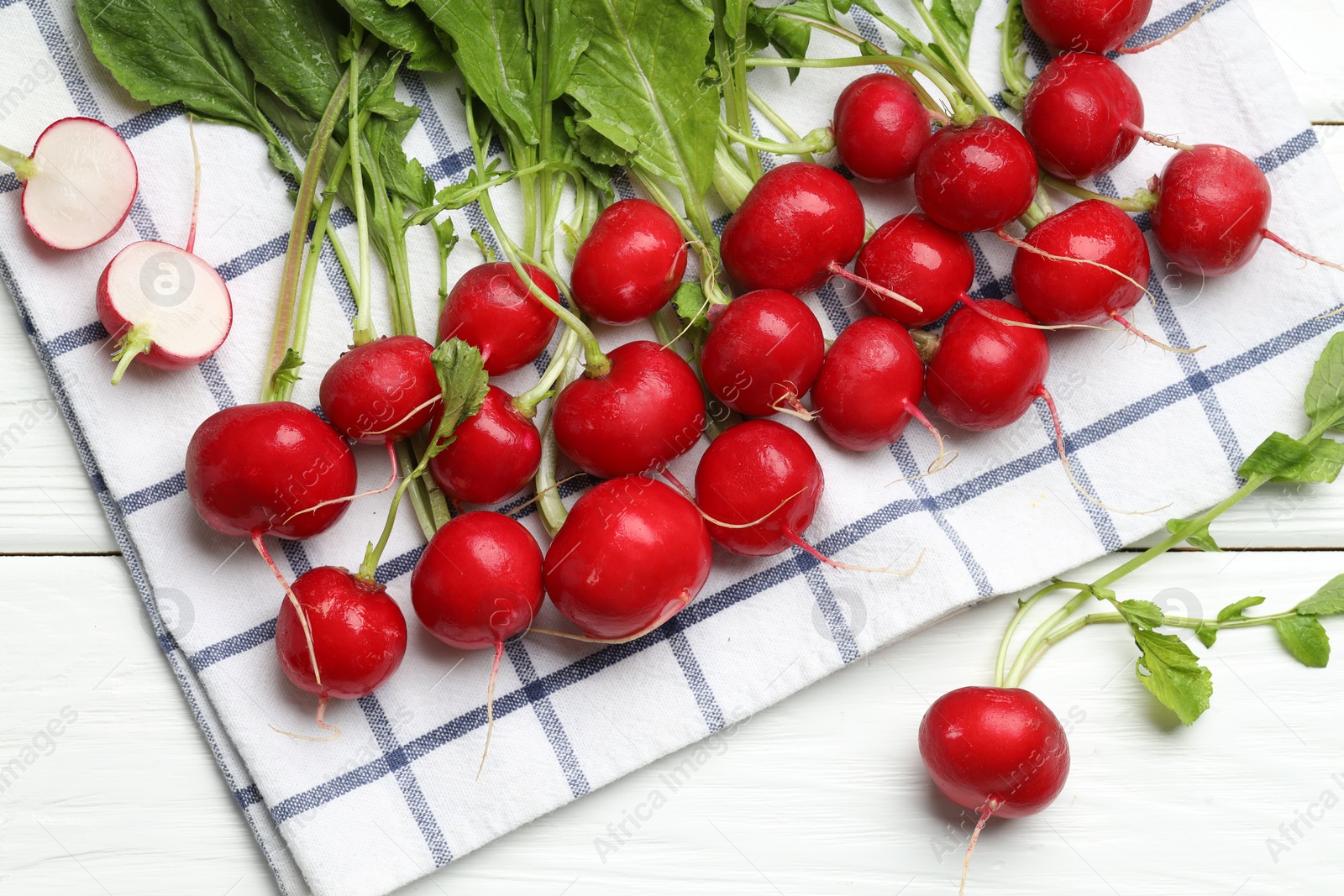 Many fresh radishes on white wooden table, flat lay Photo of Many fresh radishes on white wooden table, flat lay