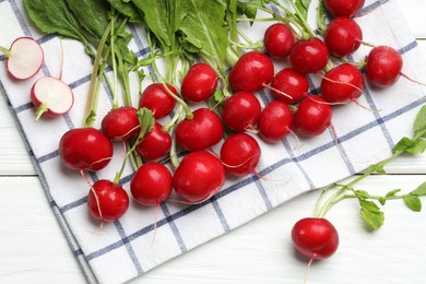 Photo of Many fresh radishes on white wooden table, flat lay