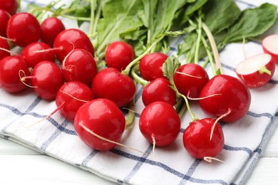 Photo of Many fresh radishes on white wooden table, closeup