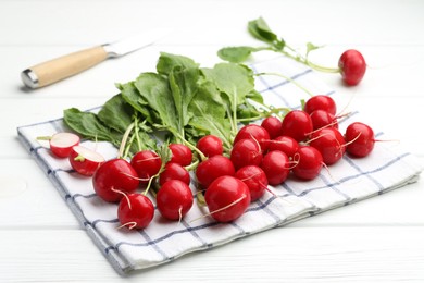 Photo of Many fresh radishes on white wooden table, closeup