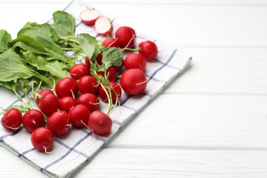 Photo of Many fresh radishes on white wooden table, closeup. Space for text