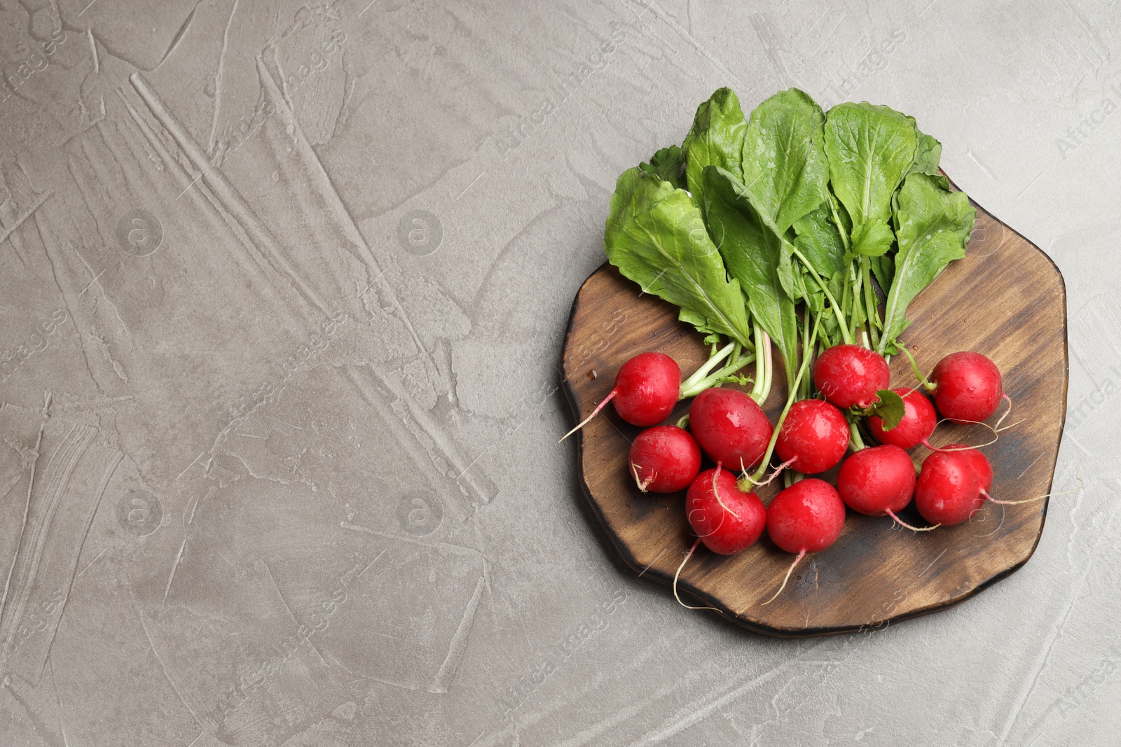 Many fresh radishes on grey textured table, top view. Space for text Photo of Many fresh radishes on grey textured table, top view. Space for text