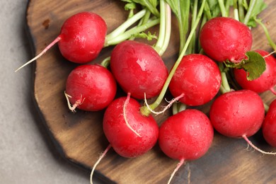 Photo of Many fresh radishes on grey table, top view