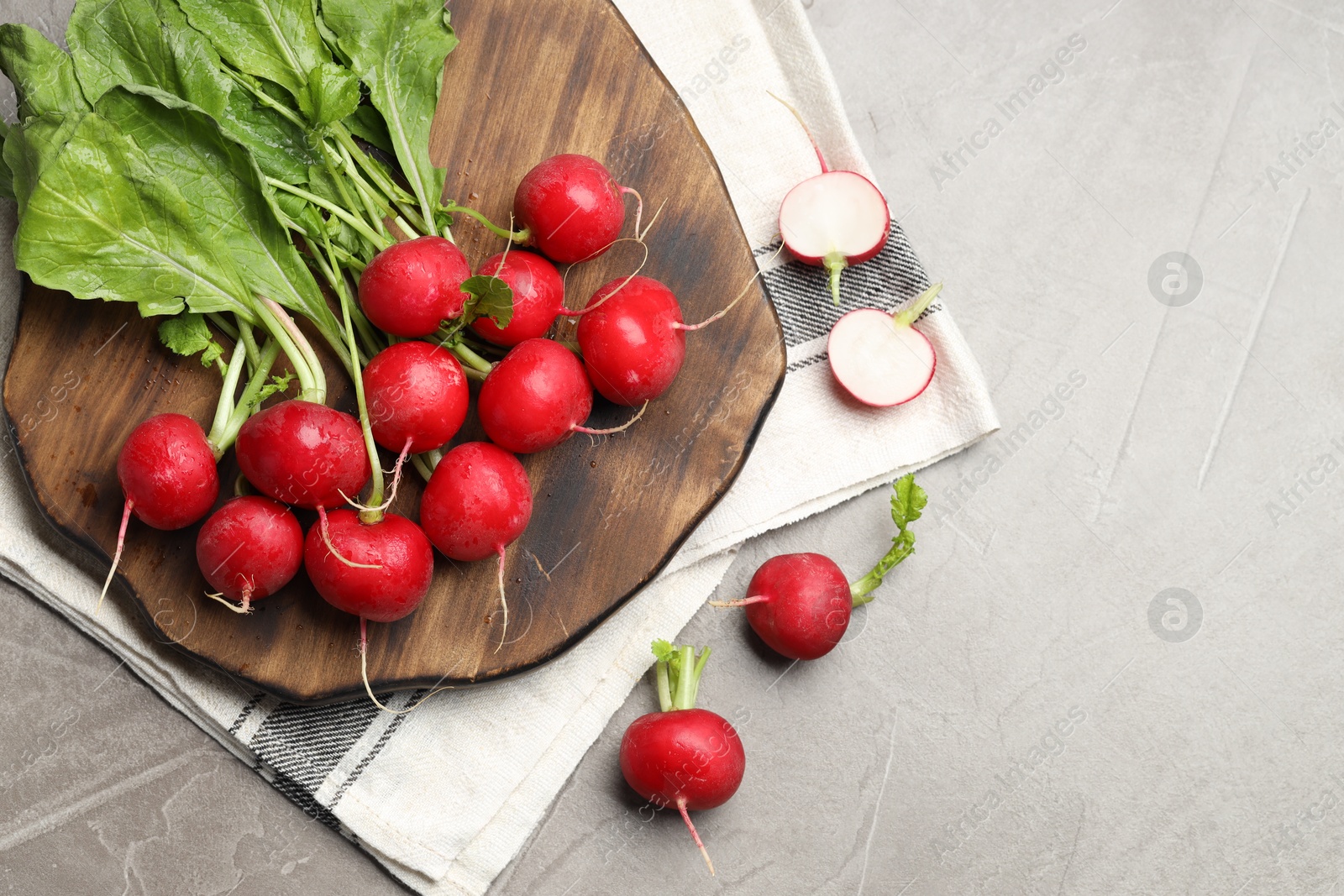 Many fresh radishes on grey textured table, flat lay. Space for text Photo of Many fresh radishes on grey textured table, flat lay. Space for text
