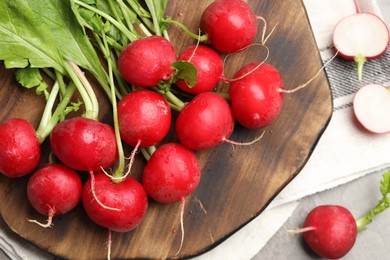 Photo of Many fresh radishes on grey table, flat lay