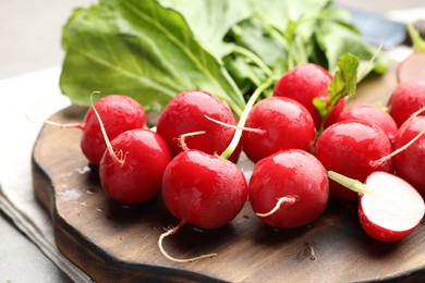 Photo of Many fresh wet radishes on table, closeup