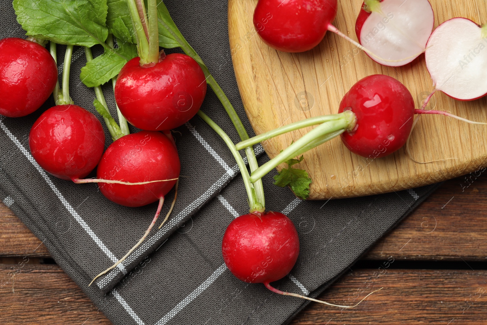 Photo of Many fresh radishes on wooden table, top view