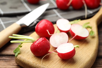 Photo of Many fresh radishes on wooden table, closeup