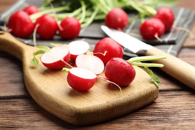 Photo of Many fresh radishes on wooden table, closeup