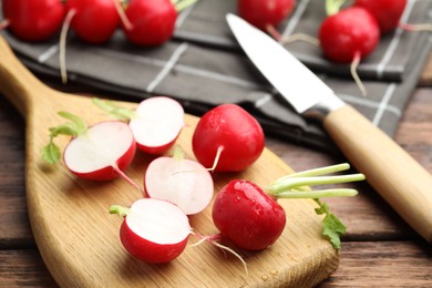 Photo of Many fresh radishes on wooden table, closeup