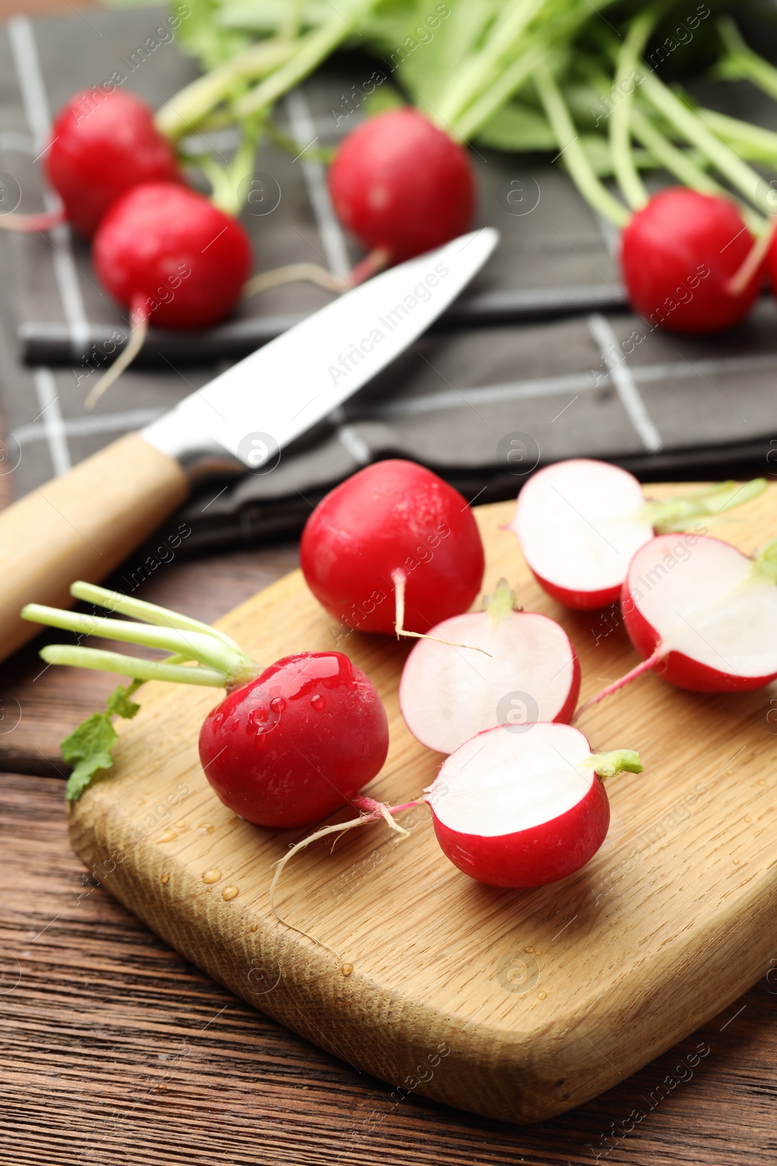 Photo of Many fresh radishes on wooden table, closeup