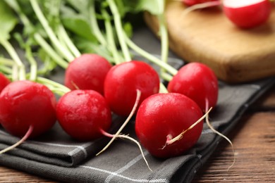 Photo of Many fresh radishes on wooden table, closeup