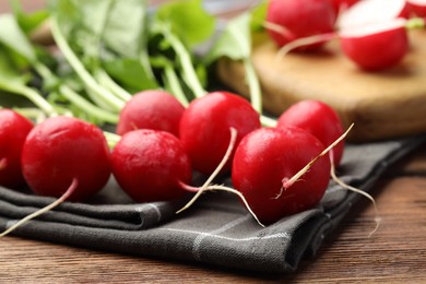 Photo of Many fresh radishes on wooden table, closeup
