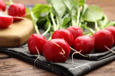 Photo of Many fresh radishes on wooden table, closeup