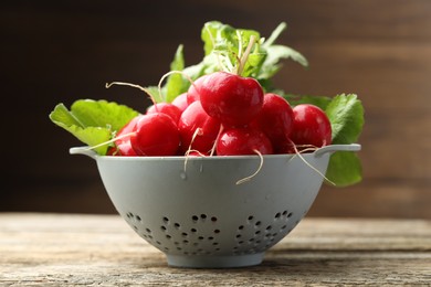 Photo of Many fresh radishes on wooden table, closeup