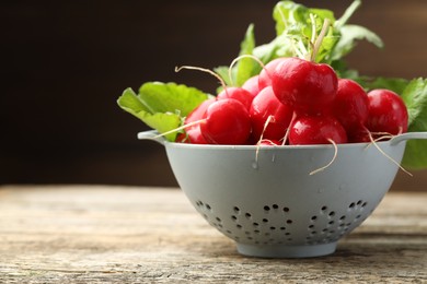 Photo of Many fresh radishes on wooden table, closeup. Space for text