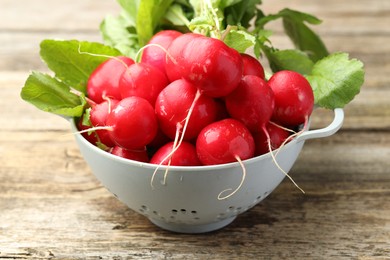 Photo of Many fresh radishes on wooden table, closeup