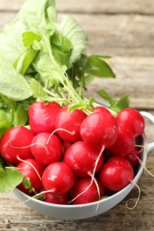 Photo of Many fresh radishes on wooden table, closeup